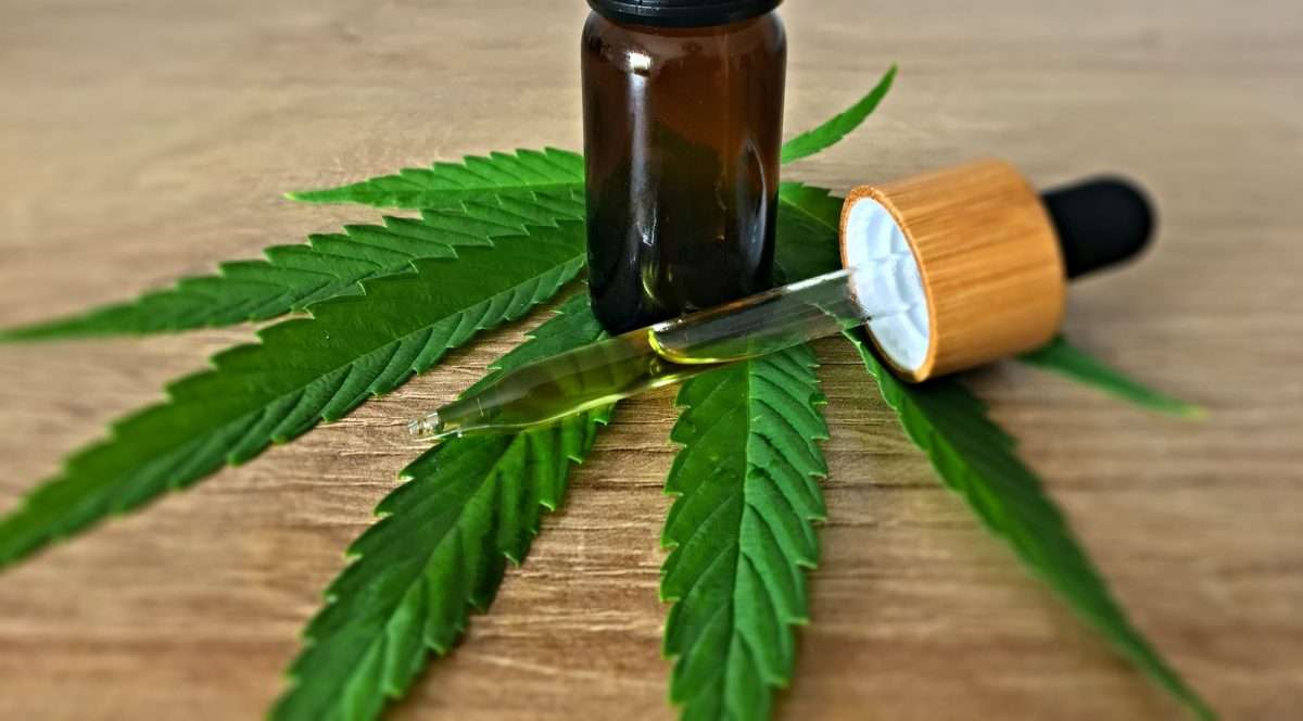 unlabeled tincture atop hemp leaf